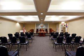Palmetto apartment for rent - a conference room with rows of chairs and a podium in the center of the room