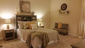 Palmetto apartment for rent - a bedroom with a bed and a chair and a dresser
