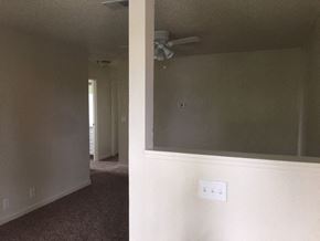 Hollister apartment for rent - a living room with a ceiling fan and a mirror