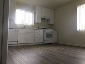 Hollister apartment for rent - an empty kitchen with white cabinets and a stove