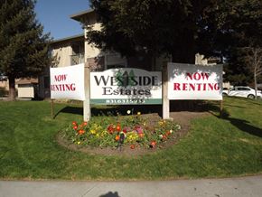 Hollister apartment for rent - three signs in the grass in front of a building