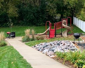 Northfield apartment for rent - a playground in a park next to a sidewalk