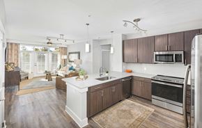 Greenville apartment for rent - A kitchen with wooden cabinets and a white island.