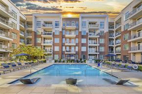Greenville apartment for rent - A large swimming pool in front of apartment buildings.