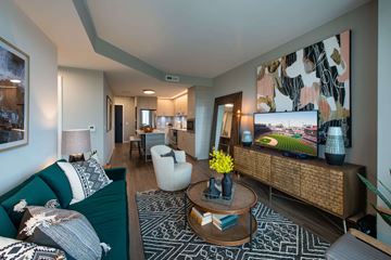 Washington apartment for rent - A living room with a green couch and a coffee table.