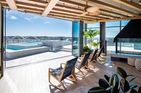 Washington apartment for rent - A sunny day at the poolside with chairs and plants.