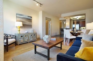 San Diego apartment for rent - A living room with a blue couch and a wooden coffee table.