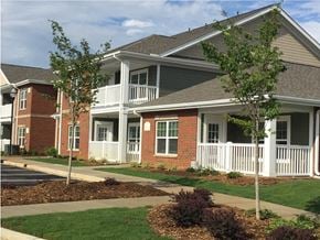 Clover apartment for rent - A house with a white porch and a brick exterior.