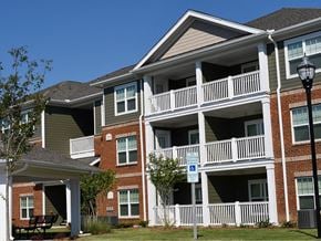 Clover apartment for rent - Apartment building with a blue sign on the railing.