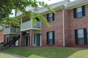Prattville apartment for rent - A red brick building with a white roof and a balcony.