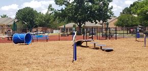 Prattville apartment for rent - A playground with a blue slide and a red flag.
