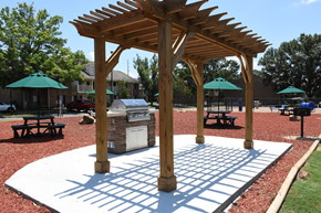 Prattville apartment for rent - A wooden pavilion with a white base is in the middle of a park.