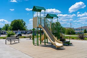 Iowa City apartment for rent - a playground with a slide and benches in a park
