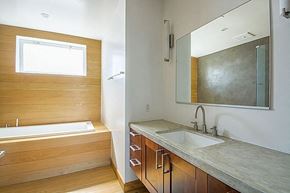 Santa Barbara apartment for rent - A bathroom with a tub, sink and mirror.