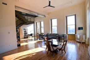 Louisville apartment for rent - an empty living room with a dining room table and chairs
