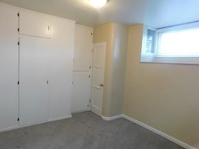San Diego apartment for rent - an empty room with white cabinets and a window
