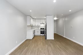 San Francisco apartment for rent - A kitchen with white cabinets and a wooden floor.