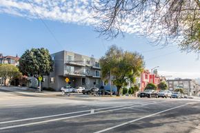 San Francisco apartment for rent - A street view of a residential area with cars parked on the side of the road.