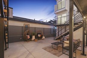 Seal Beach apartment for rent - a patio with chairs and a table and a staircase