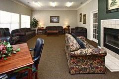 Statesville apartment for rent - a living room with couches a table and a fireplace