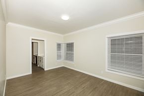San Francisco apartment for rent - A room with wooden floors and a window with blinds.