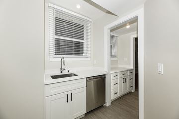 San Francisco apartment for rent - A kitchen with white cabinets and a stainless steel dishwasher.