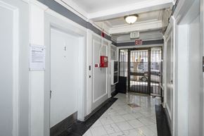 San Francisco apartment for rent - A hallway with a red exit sign above the door.