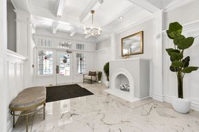 San Francisco apartment for rent - A white marble room with a fireplace and a mirror.