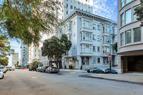 San Francisco apartment for rent - A street view of a residential area with cars parked on the side of the road.