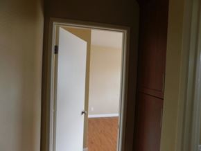 San Diego apartment for rent - A white door is open to a room with wooden flooring.