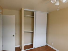 San Diego apartment for rent - A room with a white door and a white closet with shelves.