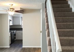 Reseda apartment for rent - an empty staircase in a home with a kitchen and a ceiling fan