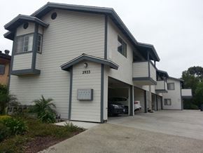 San Diego apartment for rent - a white and blue house with a car garage