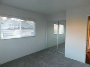 San Diego apartment for rent - an empty room with a window and a mirrored closet