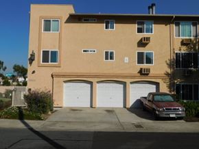 San Diego apartment for rent - a car parked in a driveway in front of a building