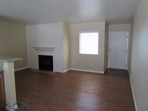 San Diego apartment for rent - an empty living room with wood floors and a fireplace