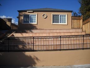 San Diego apartment for rent - A house with a black fence in front of it.