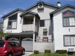 San Diego apartment for rent - A red car is parked in front of a two-story house.