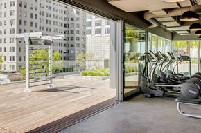 Oakland apartment for rent - the gym on the roof of the building has cardio equipment and a large window
