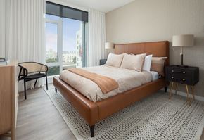 Oakland apartment for rent - a bedroom with a bed and a large window