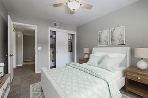 Omaha apartment for rent - a bedroom with a white bed and a ceiling fan