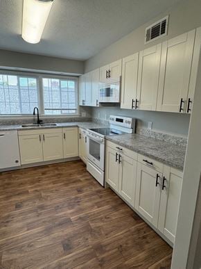 Omaha apartment for rent - A kitchen with white cabinets and a granite countertop.