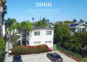 San Diego apartment for rent - a large white house with cars parked in front of it