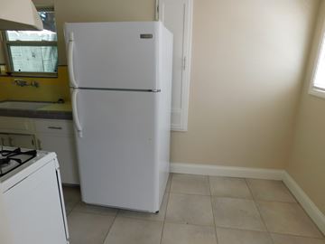 San Diego apartment for rent - a kitchen with a refrigerator and a stove and a window