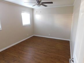 San Diego apartment for rent - a empty room with wooden floors and a ceiling fan