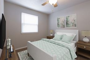 Omaha apartment for rent - a bedroom with a bed and a ceiling fan