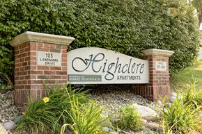 Council Bluffs apartment for rent - A sign for Highclere Apartments is displayed in front of a green hedge.