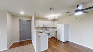 Council Bluffs apartment for rent - A kitchen with white cabinets and a grey door.