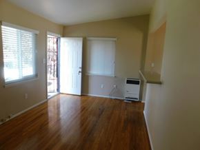 La Mesa apartment for rent - an empty living room with wood floors and a door