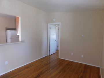 La Mesa apartment for rent - an empty living room with a hard wood floor and white walls